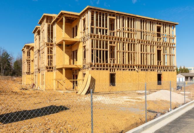 a close-up of temporary chain link fences enclosing a job site, signaling progress in the project's development in Woodbridge